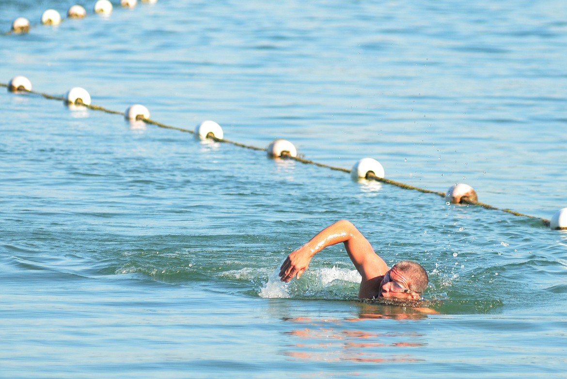 Sam Dauenhauer swims to shore at City Beach Sunday in the first leg of the Whitefish Lake Triathlon.