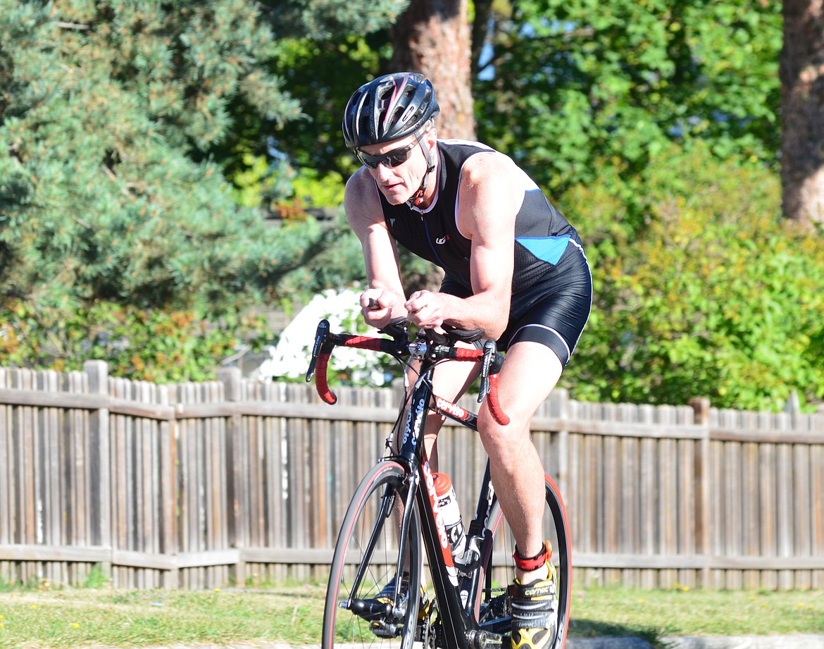 A competitor heads out from City Beach at the beginning of the 20-kilometer bike portion of the Whitefish Lake Triathlon Sunday. Heidi Desch / Whitefish Pilot