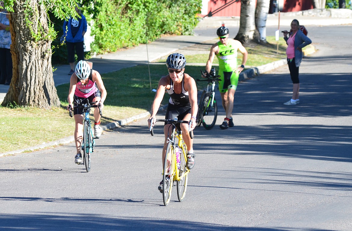 Competitors in the Whitefish Lake Triathlon Sunday leave the transition area to begin the start of the 20-kilometer bike portion of the spring triathlon that begins and ends at City Beach. Heidi Desch / Whitefish Pilot