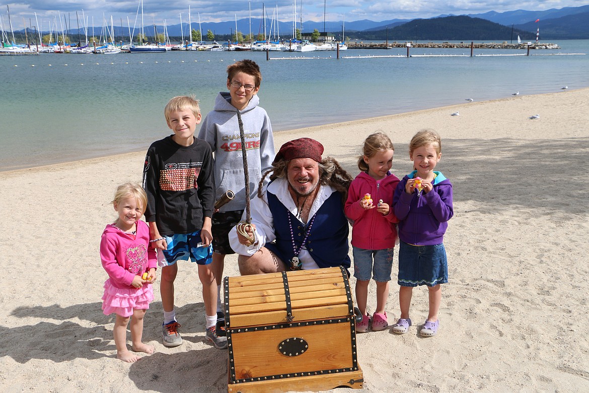 &#151; Photo by MARY MALONE
Captain Dan Mimmack poses on City Beach in Sandpoint with the Muhly family from Coeur d'Alene after the five kids &quot;plundered&quot; his pirate treasure. From left to right:  Abi, 2; Nathaniel, 9; David, 11; Captain Dan; and twins Rebecca and Hannah, 4.