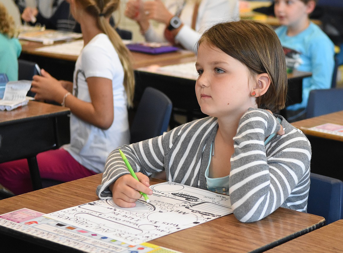 Gabrielle Middleton writes on a worksheet in Mrs. Koopal&#146;s second-grade class.