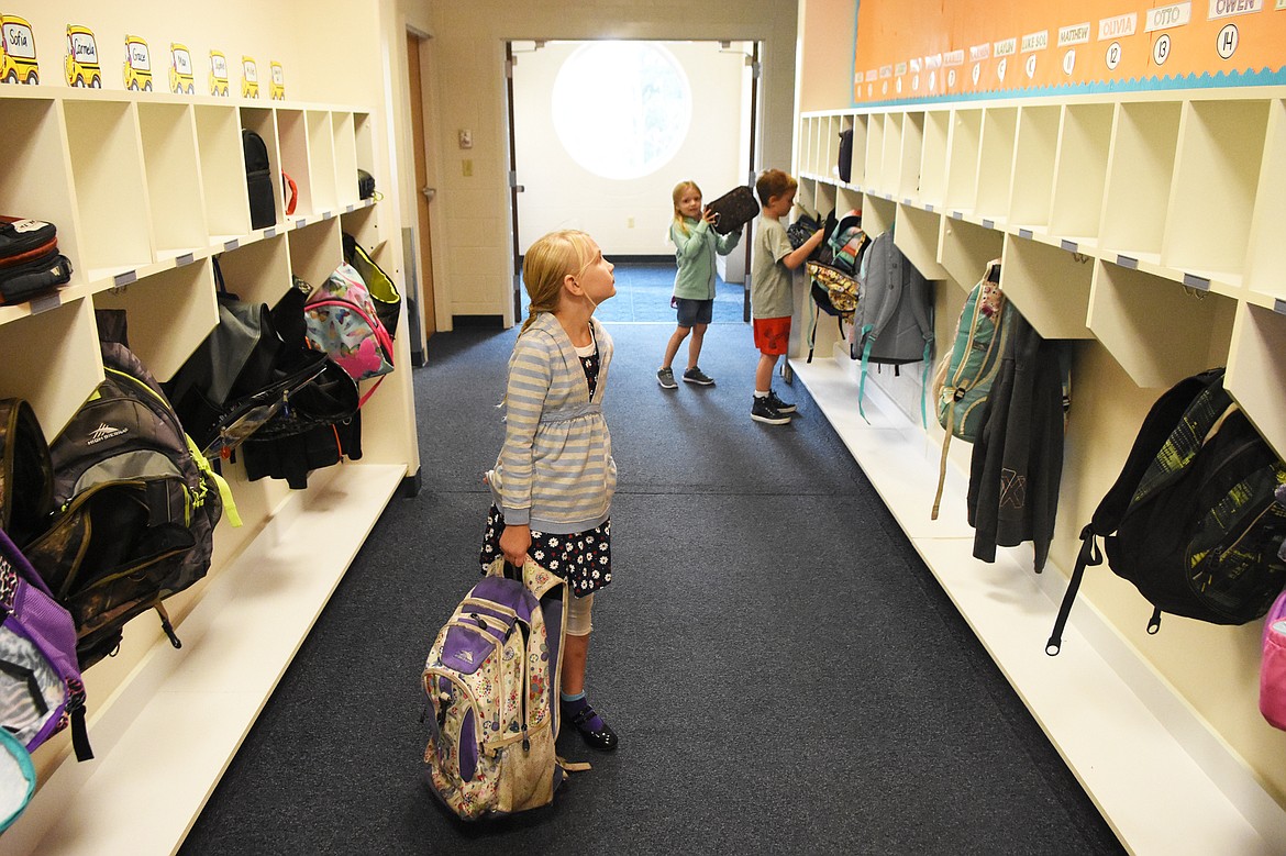 Second-grade students search for their cubbies.