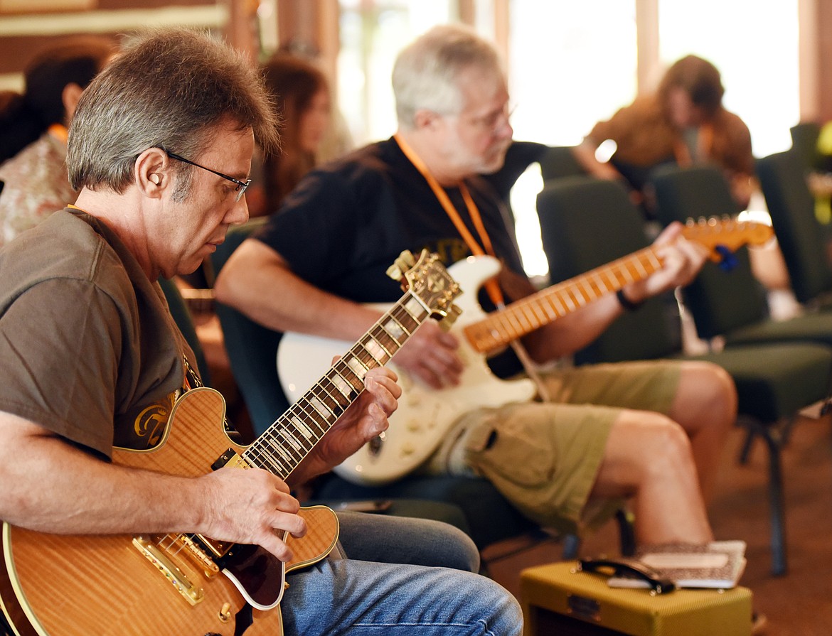 Joe Guzzi of Chicago practices playing as he listens to Jared Meeker and Dweezil Zappa in the Excel with the Masters class on Monday morning at the Seventh Annual Crown Guitar Workshop at Flathead Lake Lodge. (Brenda Ahearn photos/Daily Inter Lake)