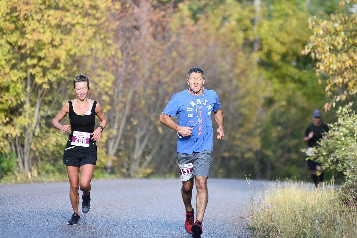 Sabina Lomozova and  Dominic Cerulli of Whitefish run along East Lakeshore during the half marathon Sunday in the Two Bear Marathon. Heidi Desch / Whitefish Pilot