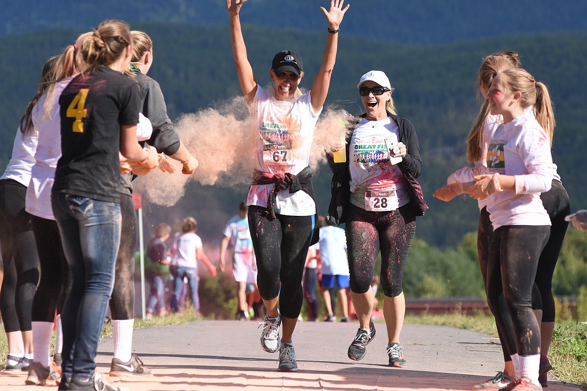 Lissa Dunker and Tory Brandt are hit with colored powder in the Great Fish Color Run on Saturday in Whitefish. The 5k run was a benefit for the Whitefish Community Foundation's Great Fish Challenge.