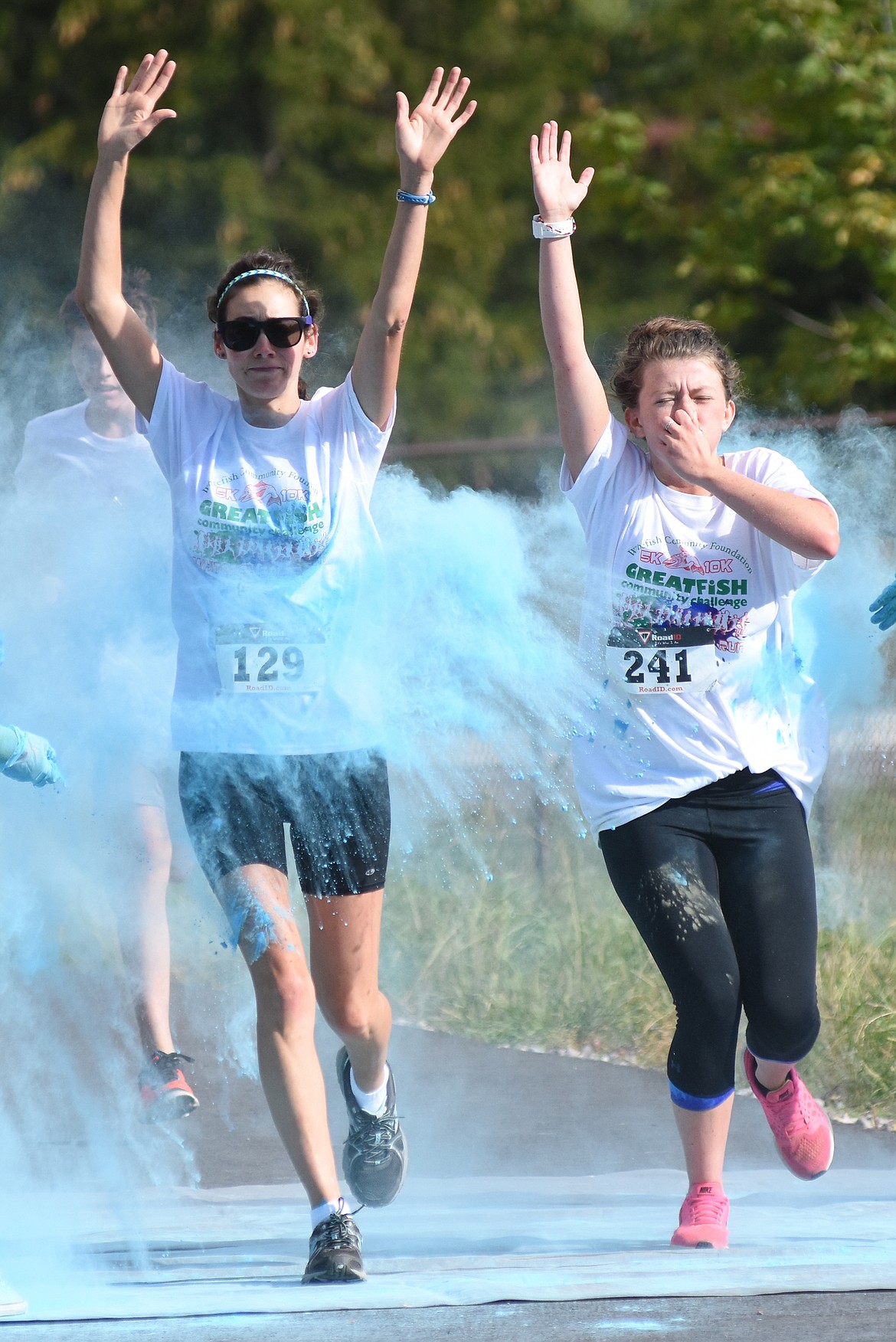 Sarah Kroll and Kt Whyte are doused with colored powder in the Great Fish Color Run on Saturday in Whitefish. The 5k run was a benefit for the Whitefish Community Foundation's Great Fish Challenge.