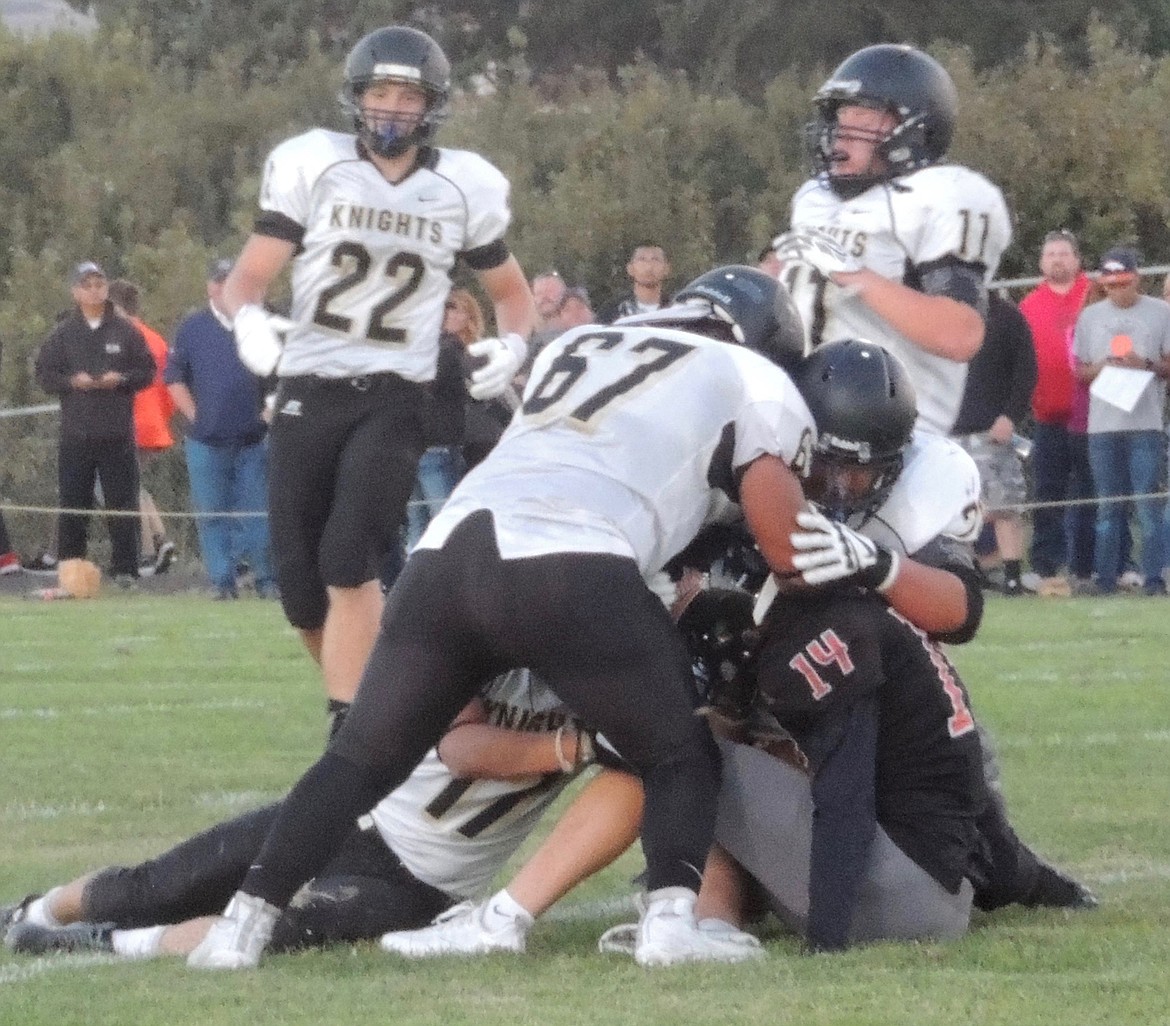 Isaac Ellis and Sawyer Stakkeland are a bit late to the party as Juan Garcia, Jhonny Garcia and Ramses Gonzalez take down the Zillah quarterback. Ted Escobar photo.