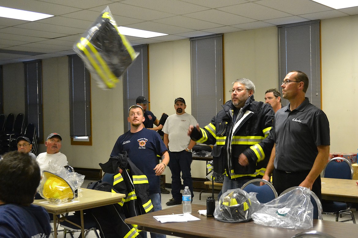 &#151;Photo by SARAH JENKINS
VIKING and the Bonners Ferry Fire Department enjoyed tossing out the new uniforms.