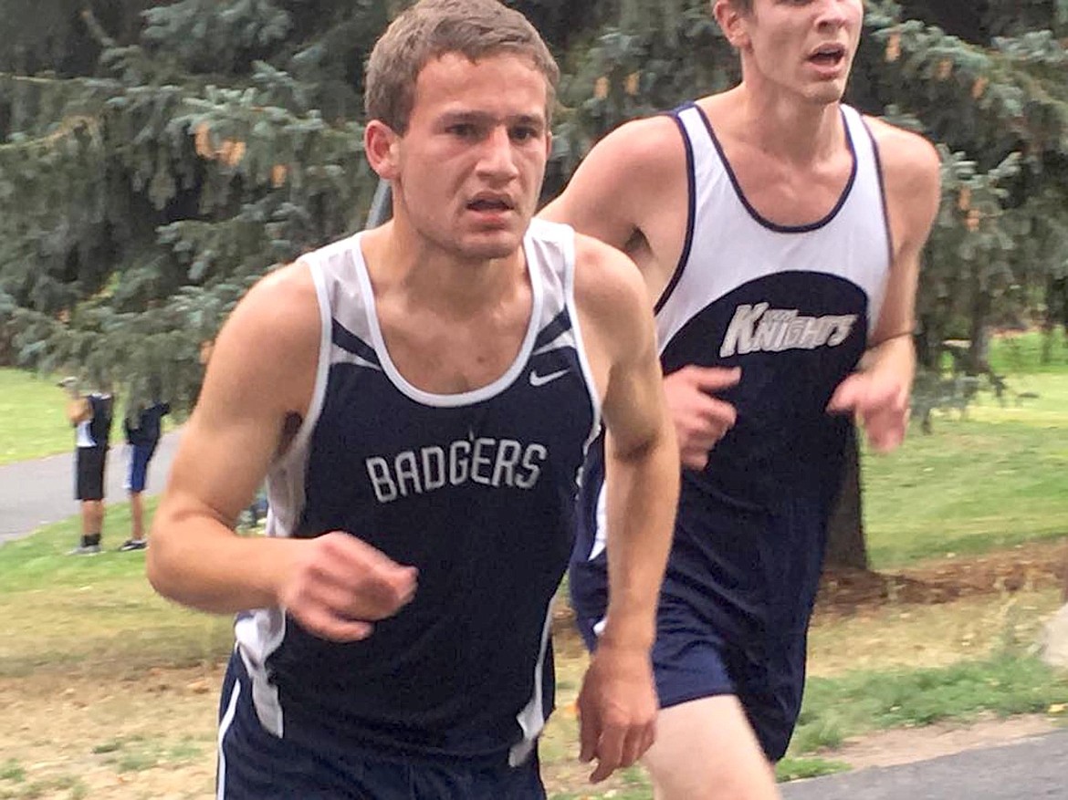 &#151;Photo courtesy TYLER WARNER
Badger Eric Ellis edges another runner at the Bob Weisil Invite in Moscow.