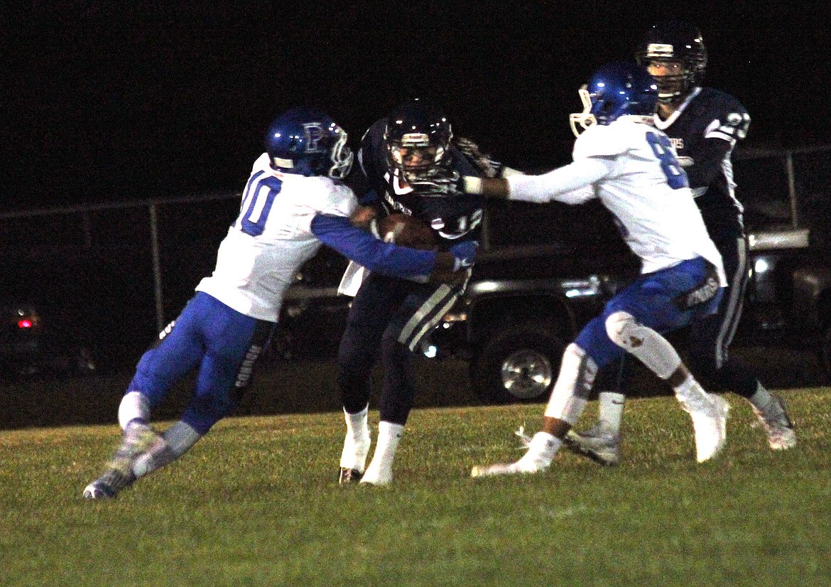 &#151;Photo by AARON BOHACHEK
Kaleb Stockton dives through Pullman defenders at the Bonners Ferry High School homecoming game Sept. 23.