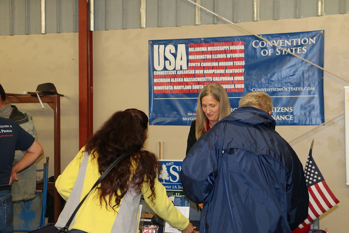 &#151; Photo by MARY MALONE
Sherie Clipson, center, Idaho Grassroots coordinator for the Convention of States project, spoke with guests of the Inland Northwest Freedom Festival Saturday, handing out information and answering questions about the COS project.