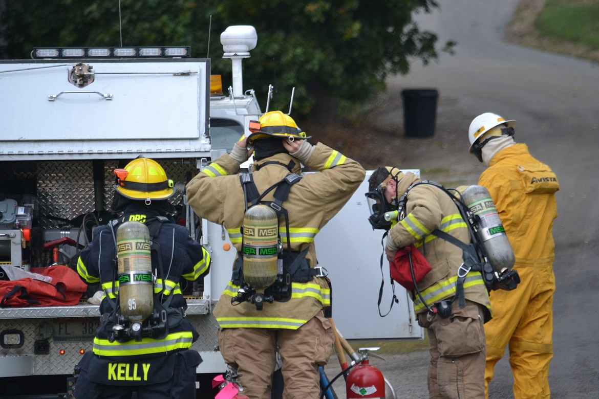 -- Photo by SARAH JENKINS

BFFD and Avista representatives suit up to shut off the natural gas leak, Wednesday.