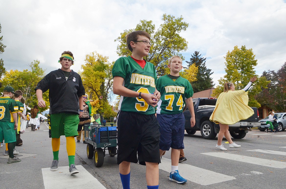 Youngsters walk down Second Street Friday during the Whitefish High School homecoming parade.