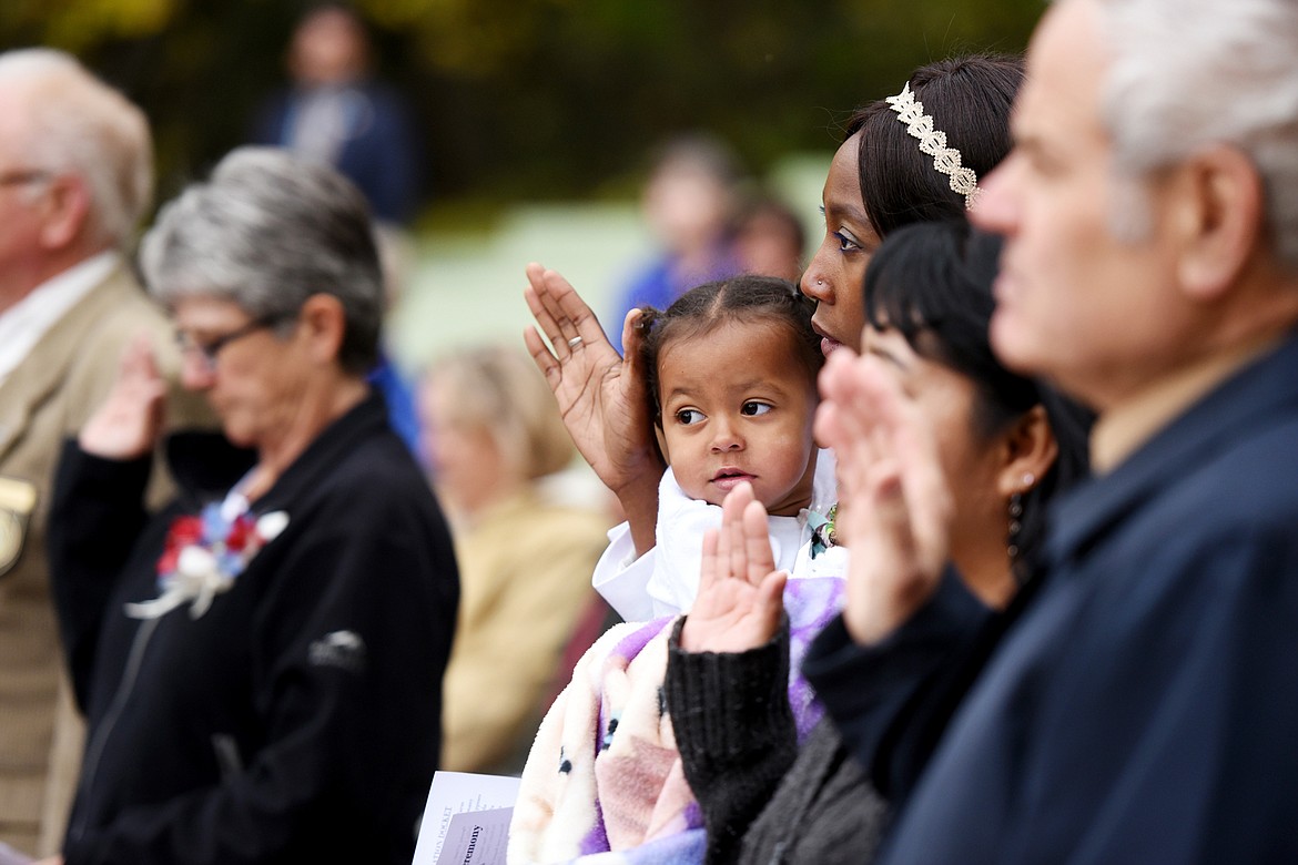 Sandrine Tochem of Chad gives the Naturalization Oath as she hold her two-year-old daughter Alexa at the&#160;Naturalization Ceremony in Glaicer National Park on Wednesday, September 21.&#160;(Brenda Ahearn photo)