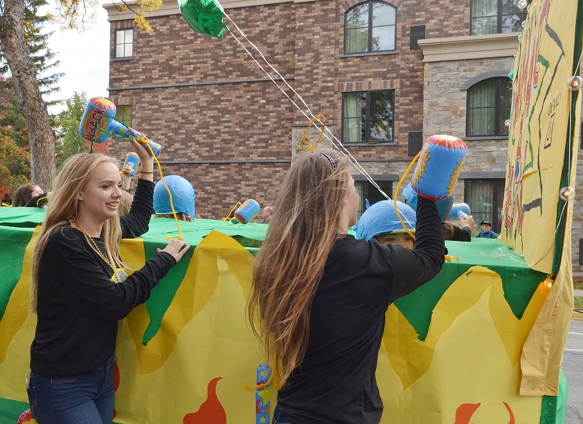 The Bulldog volleyball team plays whack-a-devil on their float in support the football team who played the Corvallis Blue Devils for Homecoming.