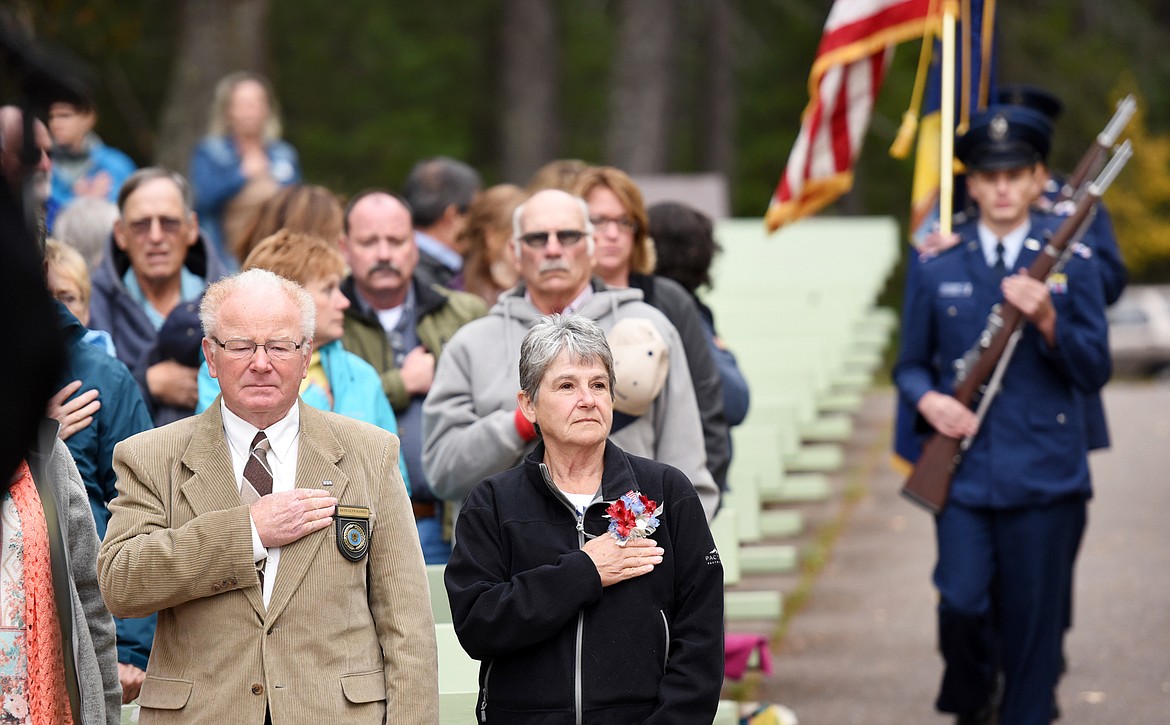 From left, Date-Ellyn&#160;Dalles Randle and Lana Lee Schock, both of Canada stand for the Advance of the Colors by the Kalispell Civil Air Patrol during the&#160;Naturalization Ceremony in Glaicer National Park on Wednesday, September 21.&#160;(Brenda Ahearn/Daily Inter Lake)