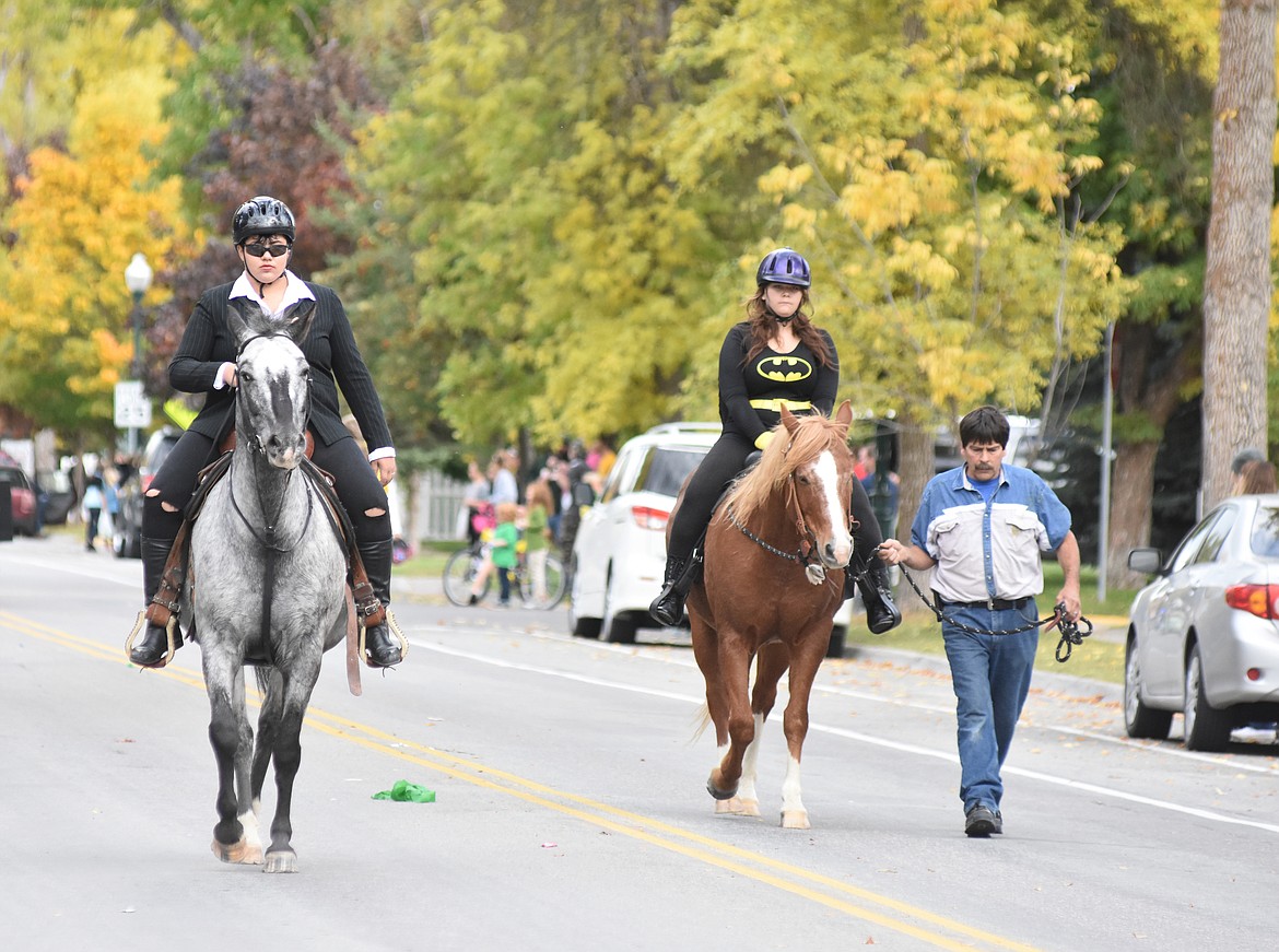 A pair of horse riders walk the parade route Friday during the Whitefish High School Homecoming parade.