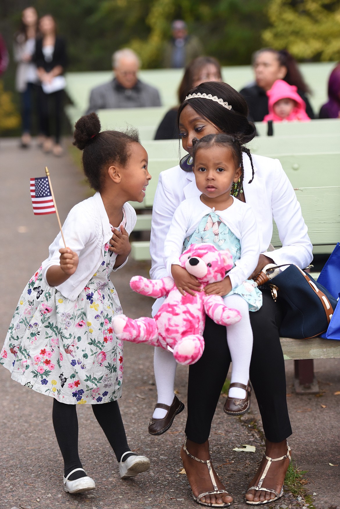 Sandrine Tochem of Chad with her daughters Eve, 5, and Alexa, 2, share a moment together before the start of the&#160;Naturalization Ceremony in Glaicer National Park on Wednesday, September 21.&#160;(Brenda Ahearn/Daily Inter Lake)