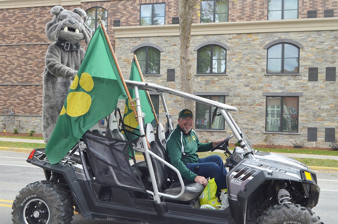 Whitefish High School Principal Kerry Drown drives the Bulldog down Second Street Friday during the Homecoming parade.