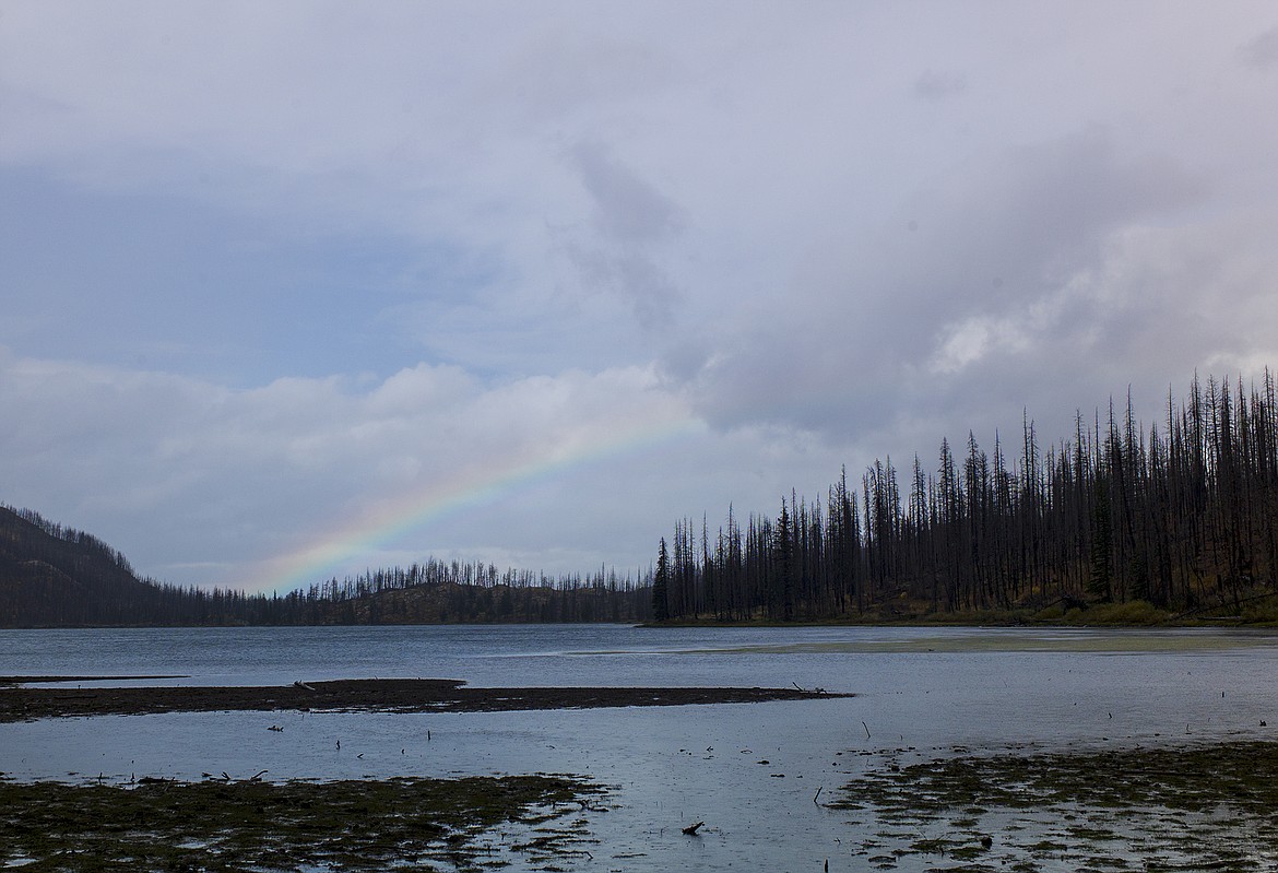 While the rain poured down, a faint rainbow hung over Red Eagle Lake for hours.