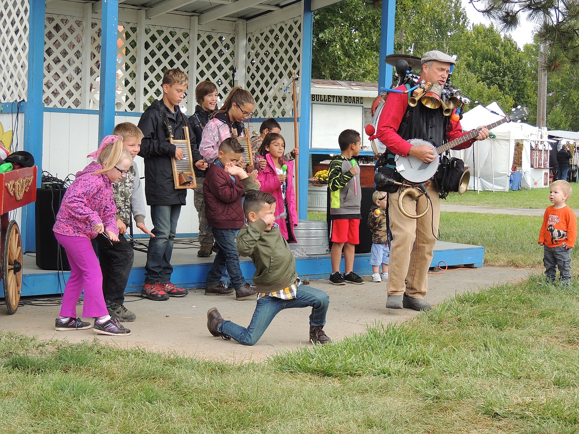 Ted Escobar/The Sun Tribune
The gloomy day didn&#146;t dampen the spirits of these youngsters at the Adams County Fair. Eric Haines, the one-man band, invited them to join his ACF symphony. One even did a little dance.