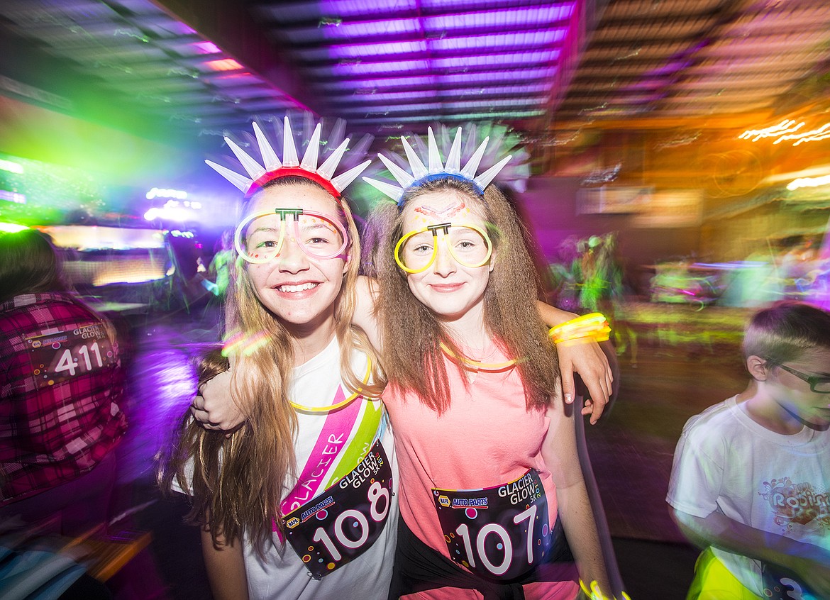 Emma Upton and Aida Collins were decked out for the Glacier Glow Run Friday night in Columbia Falls. Nearly 600 runners turned out for the event.