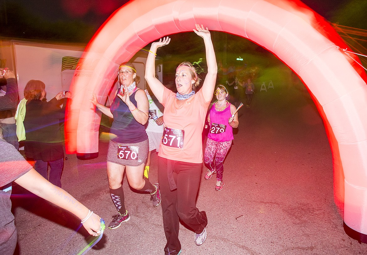 Mandy Ramesar crosses the finish line of the Glacier Glow Run in Columbia Falls Friday.