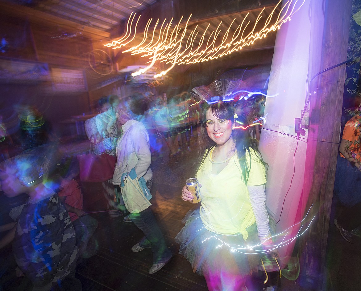 A racer enjoys the festivities at the Glacier Glow Run.