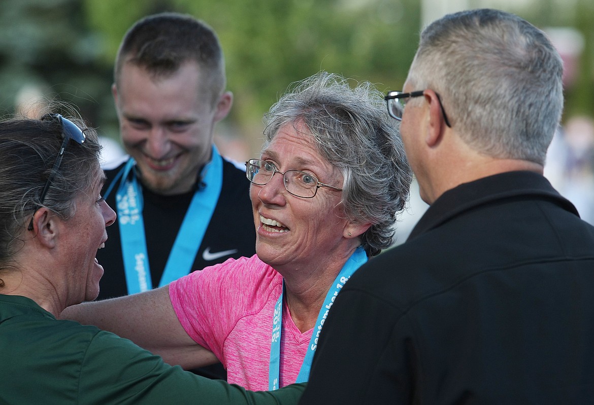 &#151;Photo by JIM McKIERNAN
Alene Gordon of Elk, Wash., is overcome with emotion after finishing the half-marathon. She receives a hug from family members after completing the race Sunday.