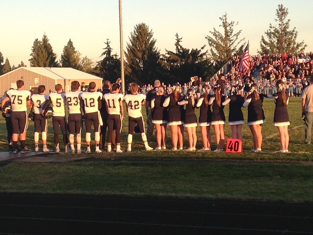 -- Photo by SARAH JENKINS

BFHS varsity cheerleaders line up next to BFHS varsity football during the National Athemn during the Freeman game.