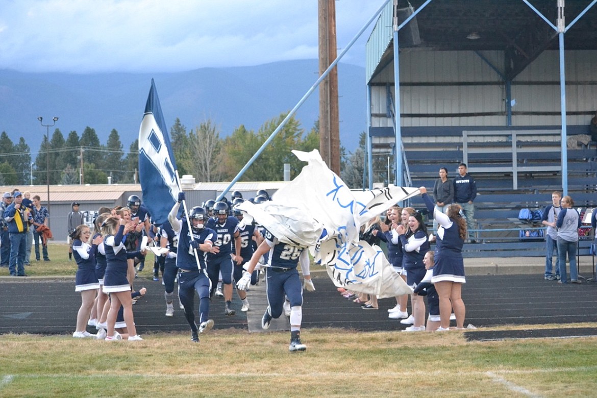 &#151;Photo by SARAH JENKINS
Badgers charge through their sign while being cheered on by the cheerleaders and Badgerettes.