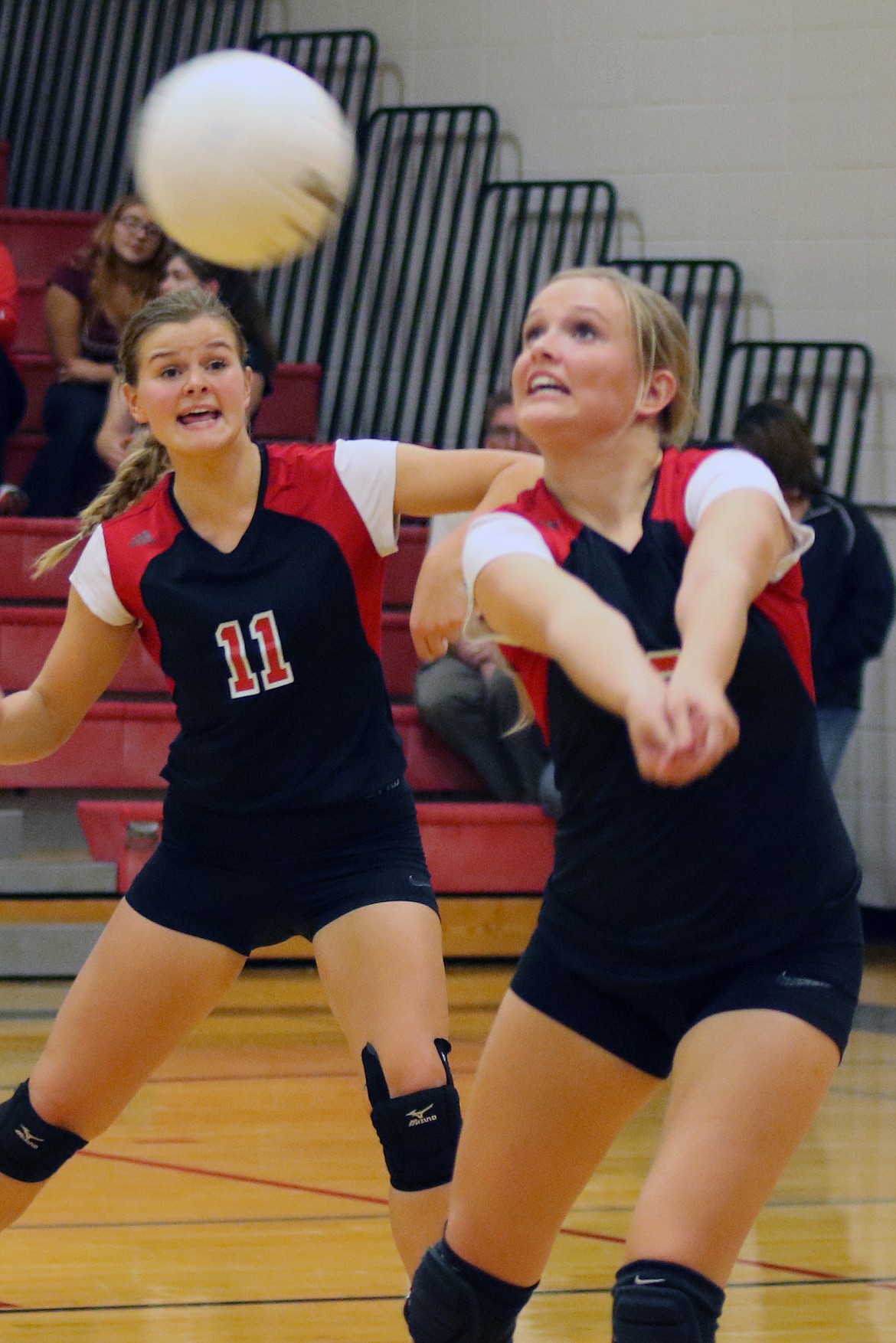 Zoee Roylance receives the serve while teammate Tanaya Andersen looks on. Bob Barrett photo.