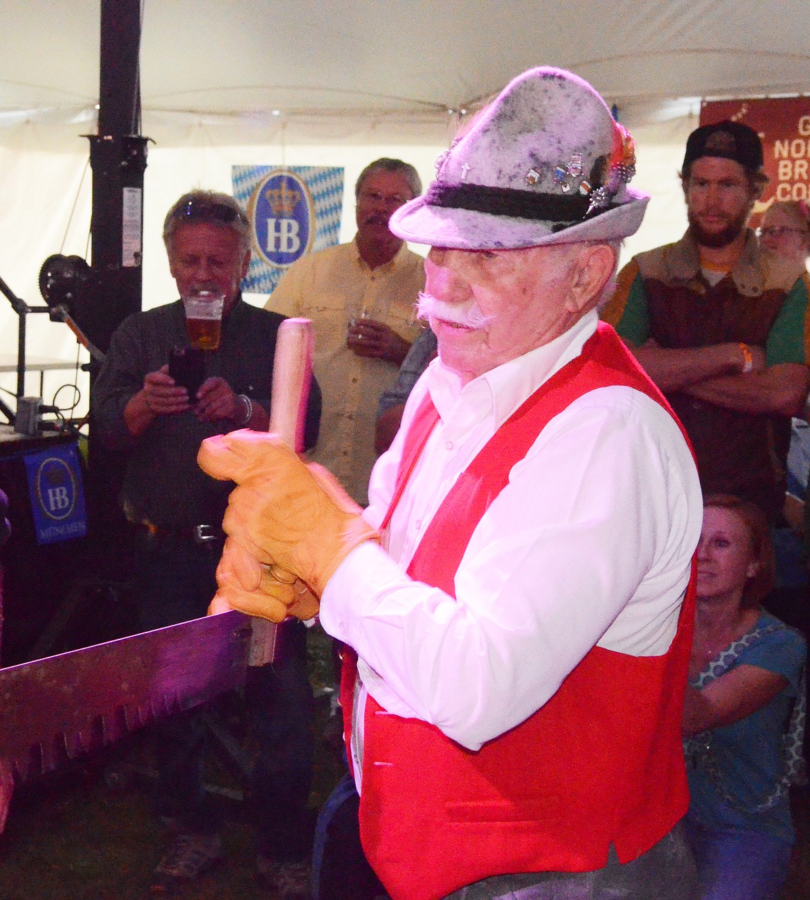 Otto Ratz pulls the saw during the men's log sawing competition Thursday evening at the Great Northwest Oktoberfest at Depot Park.