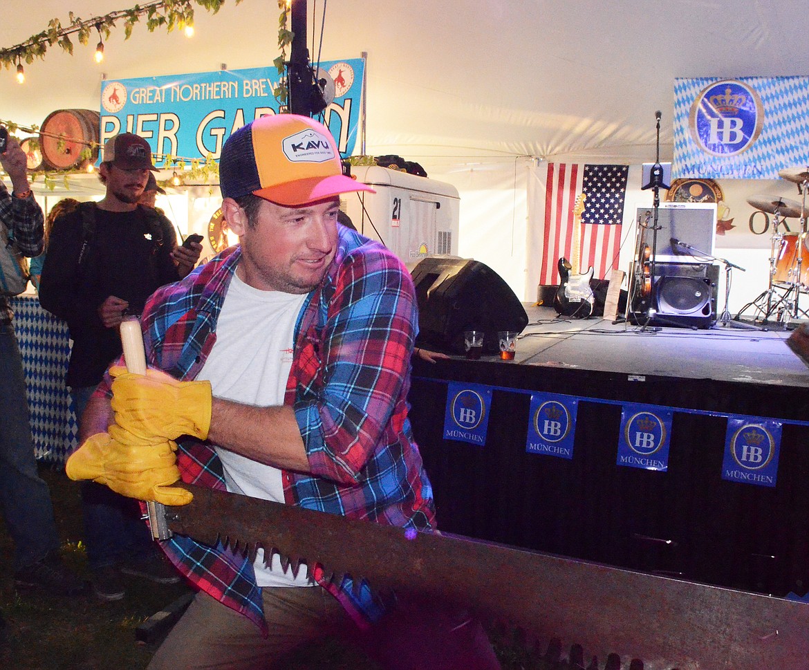 A competitor pulls the saw during the men&#146;s log sawing competition Thursday evening at the Great Northwest Oktoberfest at Depot Park.