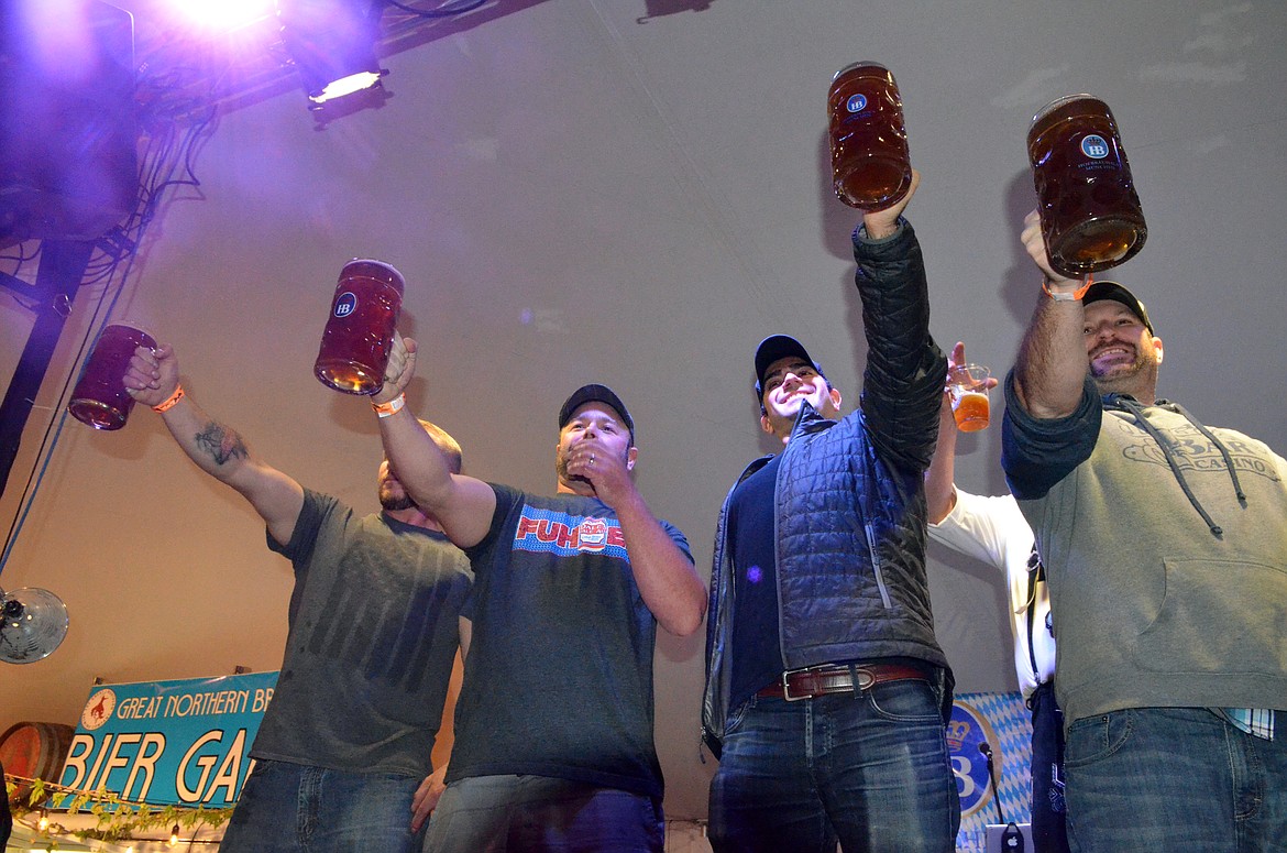 Competitors hold their steins high during the men&#146;s steinholding competition Thursday evening at the Great Northwest Oktoberfest at Depot Park.