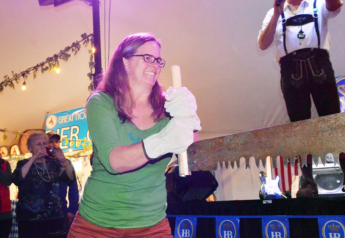 Carla Belski competes in the women&#146;s log sawing competition Thursday evening at the Great Northwest Oktoberfest at Depot Park.