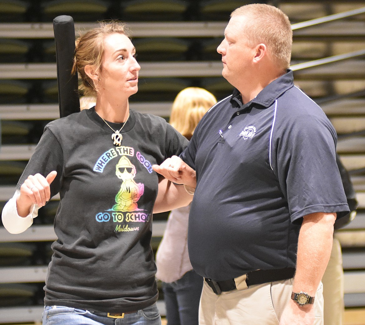 A Columbia Falls police officer teaches special education teacher&#160;Sarah Scott how to defend against an attacker with a baseball bat.