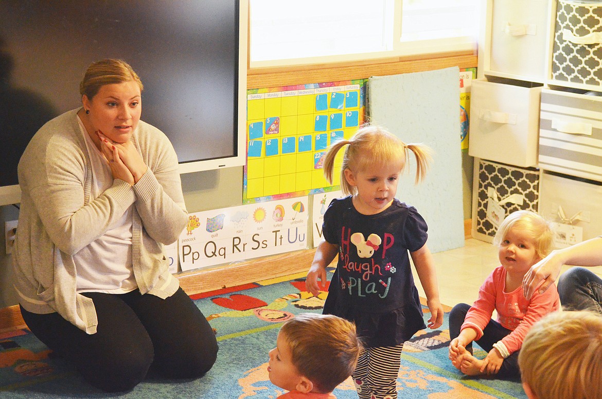 Teacher Hailey Mortensen works with preschool kids at the Whitefish Community School.