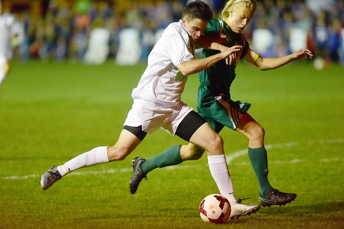 Logan Stephens drives to the goal against a Whitefish defender.