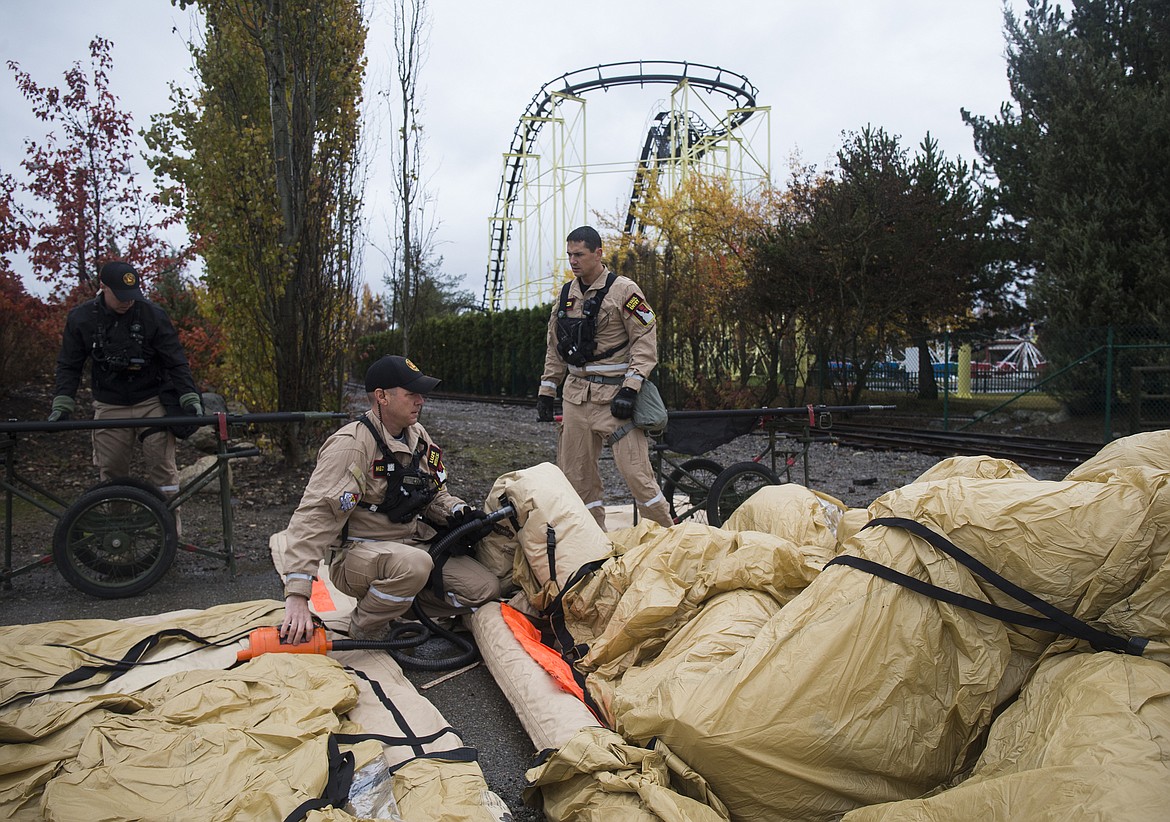 LOREN BENOIT/Hagadone News Network
Members of the Idaho National Guard&#146;s 101st Weapons of Mass Destruction Civil Support Team setup a decontamination tent during a training exercise Tuesday at Silverwood Theme Park.