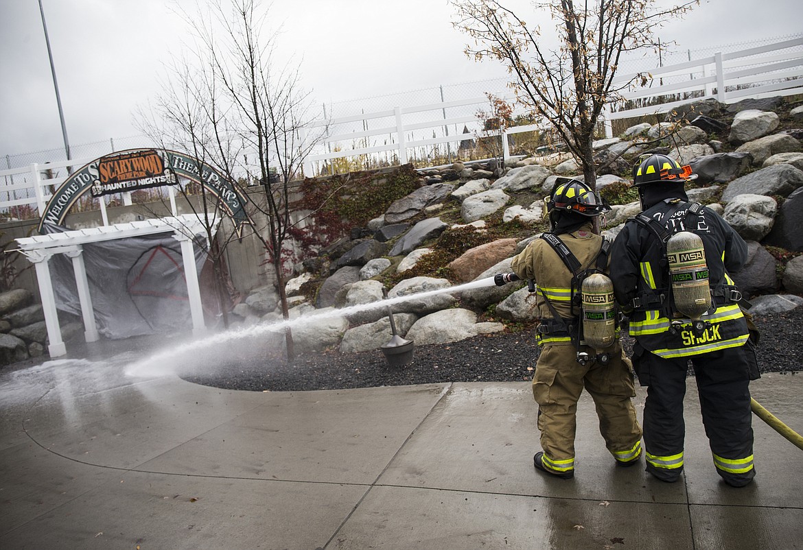 LOREN BENOIT/PressTimberlake firefighters spray the entrance of Silverwood Theme Park during an Idaho National Guard training exercise on Tuesday.