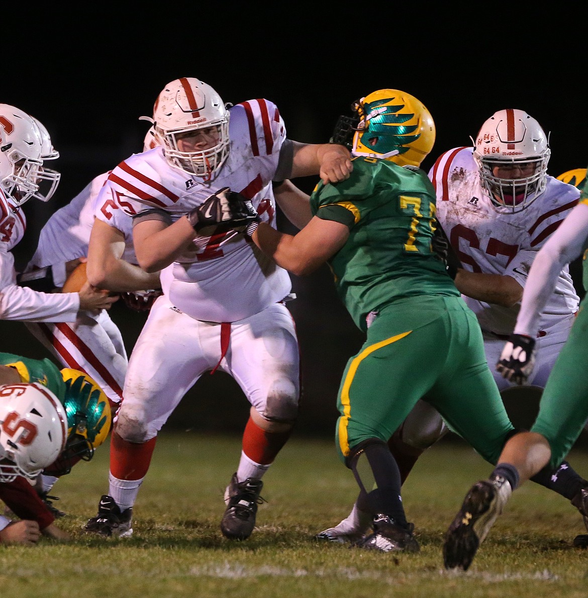 &#151;Photo by JASON DUCHOW PHOTOGRAPHY
Sandpoint offensive linemen Andrew Loutzenhiser, left, and Tyler Connolly try and create a hole in the running game on a wet and muddy field.