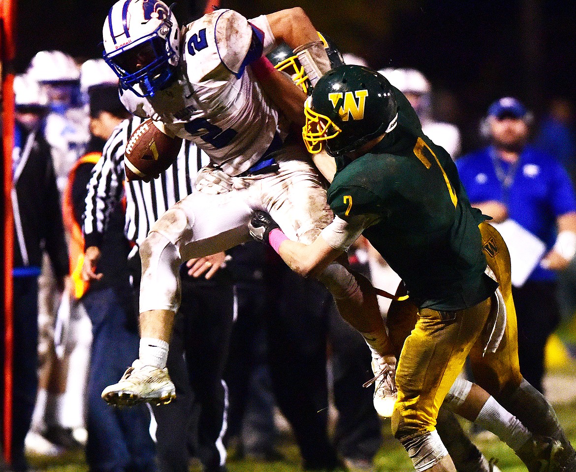 Braxton Reiten tries to leap over a Whitefish defender last week.