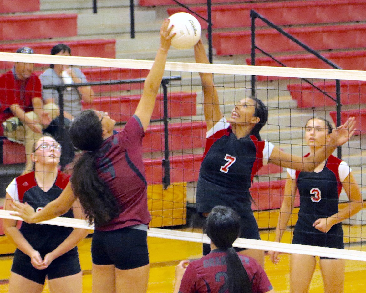 Bob Barrett Photo - Othello's Dominique Velazquez and Grandview's Madison Diener both have a hand on the volleyball during the Huskies straight set win over the Greyhounds.