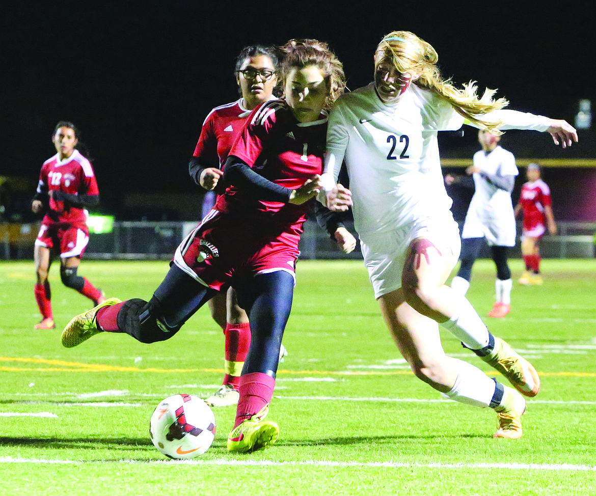 Connor Vanderweyst/Columbia Basin Herald
Moses Lake forward Abby Rathbun (22) battles for the ball against Sunnyside defender Chastitee Garza Thursday at Lions Field.