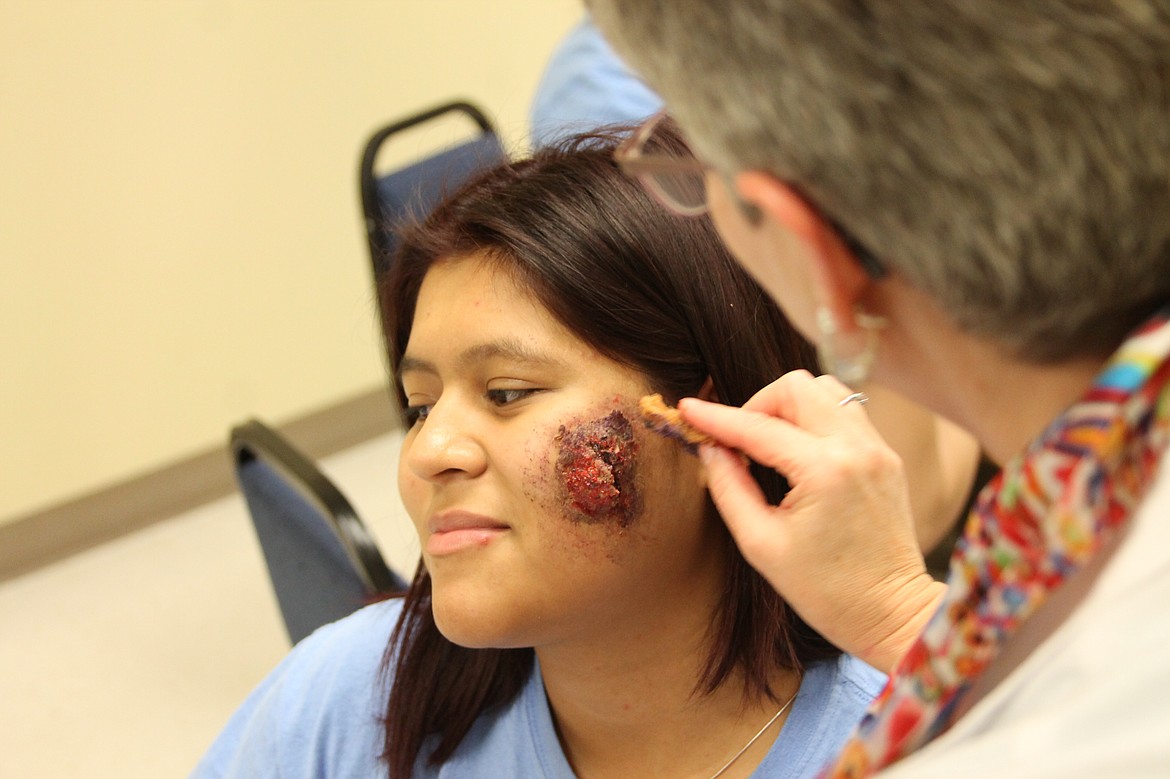 Charles H. Featherstone/Columbia Basin Herald
Instructor Laura Cromer puts the finishing touches on a lanced boil on CB Tech student Adamary Najar&#146;s face.