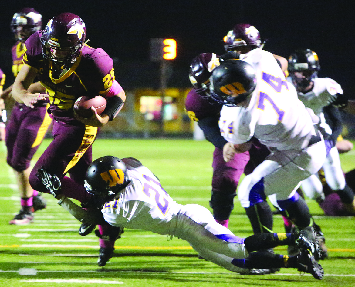 Connor Vanderweyst/Columbia Basin Herald
Moses Lake running back breaks a tackle on his way to a touchdown against Wenatchee Friday at Lions Field.