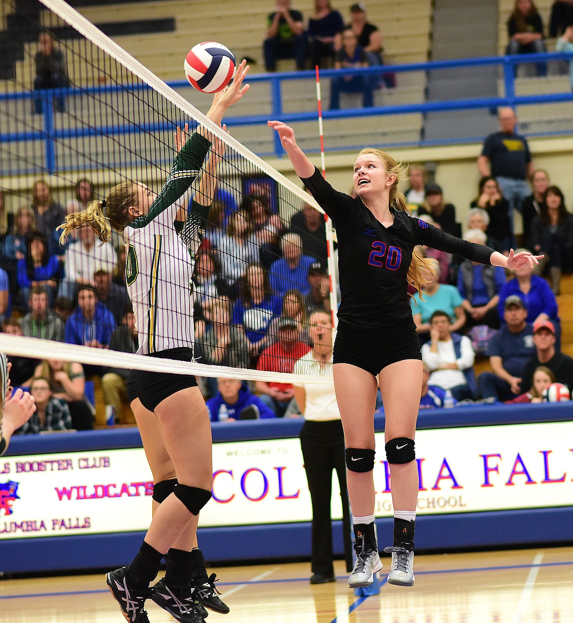 Cydney Finberg, right, slaps the ball over the net against Whitefish.