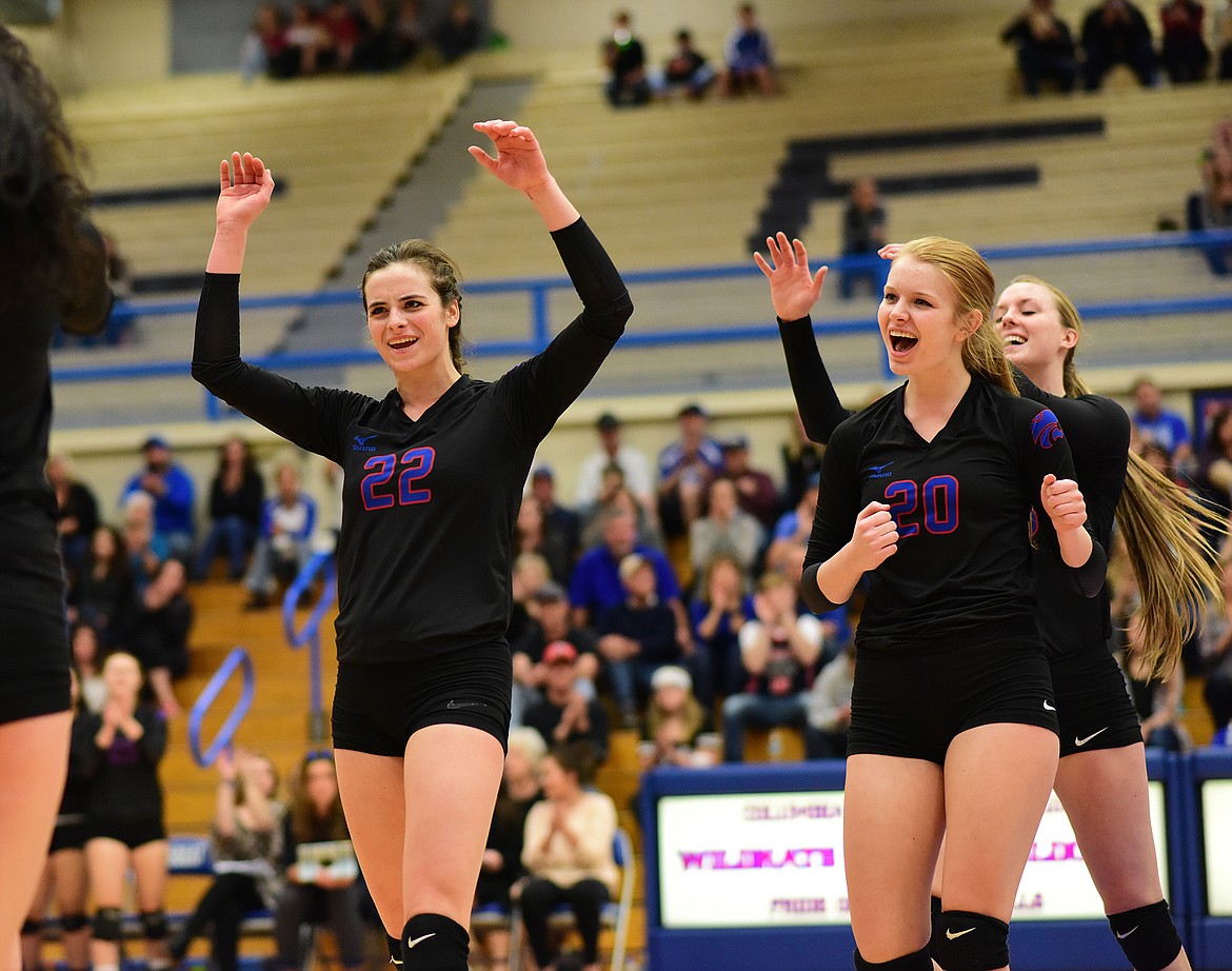 From left, Caitlyn Casazza, Cydney Finberg and Kiara Burlage celebrate a point with Morgan Stenger, out of frame.