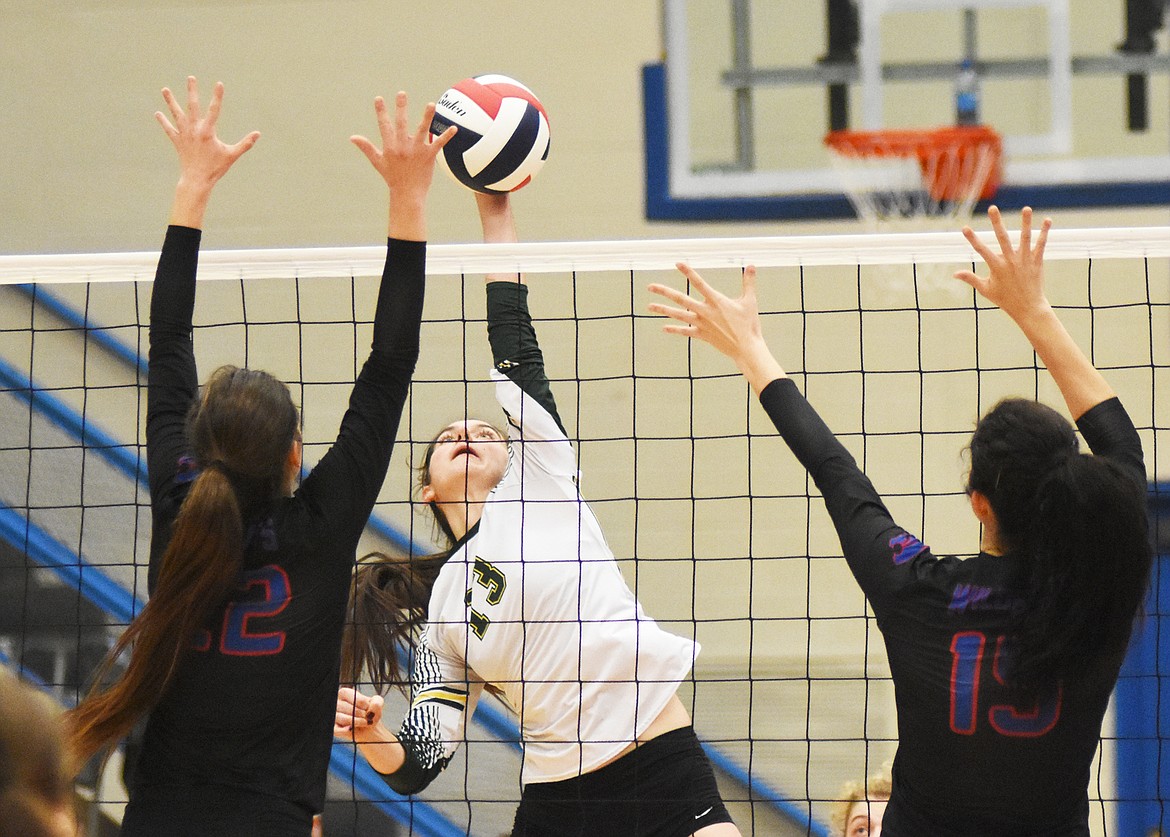 Senior Mirielle Kruger rises for a kill during the Western A divisional title match Saturday.